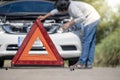 Emergency stop sign and driver near broken car on road Royalty Free Stock Photo