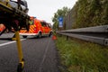 Emergency stretcher stands with a german firefighting truck on freeway