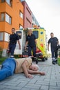 Emergency team assisting unconscious man on street