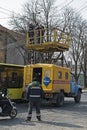 Emergency team of electricians repairing broken electrical wires for a trolleybus