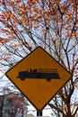 Emergency vehicle traffic sign with autumn leaves in the background