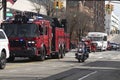 Emergency vehicles drive down a street in a village, Long Island, New York, USA