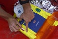 Emergency worker, paramedic hands adjusting the defibrillator preparing it to give the sufferer first aid