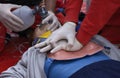 Emergency worker pressing on sufferers chest, keeping an oxygen cushion on his face. Artificial respiration