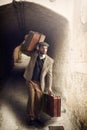 Emigrant man with the suitcases in a small town Royalty Free Stock Photo