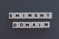 Eminent domain word made of square letter word on grey background