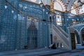 Eminonu, Istanbul, Turkey - 04.05.2021: interior of Rustem Pasa mosque with blue ornaments and a Muslim man praying inside