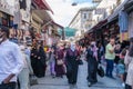 A lot of Turkish people with mask and tourists shopping and have dealings in one of the crowdest open air market place and trade