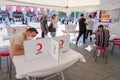 several blood donation volunteers signs checklist for official approval on a table tent of Turkish Red Crescent TÃÂ¼rk Kizilay