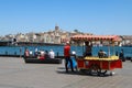 Eminonu pier, Golden horn Bay, a cart with a corn seller, Galata bridge and Galata tower in the background. Royalty Free Stock Photo
