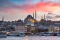 Eminonu Pier on a sunset on Golden Horn with a view of the Historic Suleymaniye Mosque on Hill in Istanbul Old City, Turkey Royalty Free Stock Photo