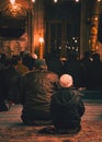 EminÃÂ¶nÃÂ¼, Istanbul / Turkey - 02 07 2014: Muslim men and child praying in Yeni Cami New Mosque interior Royalty Free Stock Photo