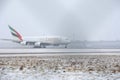 Emirates Airlines A380 taking off from snowy runway Royalty Free Stock Photo