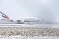 Emirates Airlines A380 taking off from snowy runway Royalty Free Stock Photo