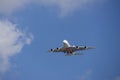 An Emirates airlines plane flying in the sky with blue sky and clouds in Inglewood California Royalty Free Stock Photo