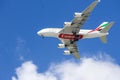 An Emirates airlines plane flying in the sky with blue sky and clouds in Inglewood California Royalty Free Stock Photo