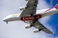 An Emirates airlines plane flying in the sky with blue sky and clouds in Inglewood California Royalty Free Stock Photo