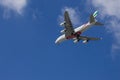 An Emirates airlines plane flying in the sky with blue sky and clouds in Inglewood California Royalty Free Stock Photo
