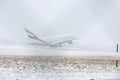 Emirates Airlines A380 taking off from snowy runway Royalty Free Stock Photo