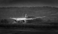 Emirates airplane landing with vortex at wingtip