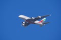 Emirates A380 giant plane in flight in mid air blue sky