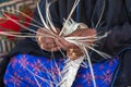 Emirati woman is weaving traditional basket from palm leaves