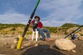 Emirdag / Afyonkarahisar - August 11 2019: Fishing rods implanted on the ground and fisherman sitting and waiting to catch fish Royalty Free Stock Photo