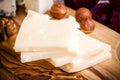 Emmental cheese close-up with nuts on a wooden board Royalty Free Stock Photo