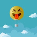 Emoticon with stuck out tongue hot air balloon flying with clouds on sky, traveling concept, Cute emoticon