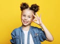 Emotion, childhood and people concept: little girl showing ok gesture