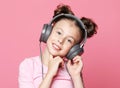 emotion, childhood, tehnology and people concept: happy girl with headphones listening to music