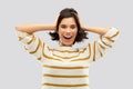 Happy woman in pullover holding to her head