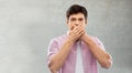 Shocked young man covering his mouth by hands Royalty Free Stock Photo