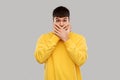 Shocked young man covering his mouth with hands Royalty Free Stock Photo