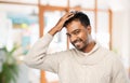 Indian man in knitted sweater touching his hair