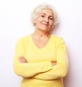 Portrait of mature woman with crossed arms over white background. Royalty Free Stock Photo