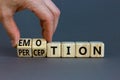 Emotion and perception symbol. Businessman turns wooden cubes and changes the word `perception` to `emotion`. Beautiful grey