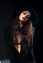 Emotion female model posing in black shirt and elegant hat Royalty Free Stock Photo