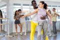 African American performing kizomba with woman in dance studio