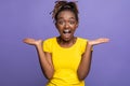 Emotional african american female expressing amazement over purple background