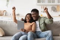 Emotional african american lovers playing online games on pad Royalty Free Stock Photo