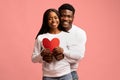 Emotional african american lovers posing with big red heart Royalty Free Stock Photo