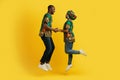 Emotional african couple holding hands and jumping up Royalty Free Stock Photo