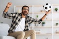 Emotional arab guy football fan watching game on TV Royalty Free Stock Photo