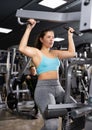Young girl working out on lat pulldown lever machine