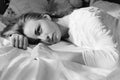 Emotional beautiful blond young woman lying in bed Royalty Free Stock Photo