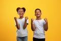 Emotional black brother and sister showing yes gesture