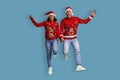 Emotional black couple holding hands and jumping up, celebrating Christmas Royalty Free Stock Photo