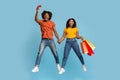 Emotional black couple with shopping bags and credit card Royalty Free Stock Photo