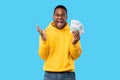 Emotional Black Man Shouting Holding Euro Money Over Blue Background